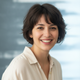 Portrait of a smiling French woman in her late 20s, with short dark hair, looking at the camera with a cheerful, trustworthy 